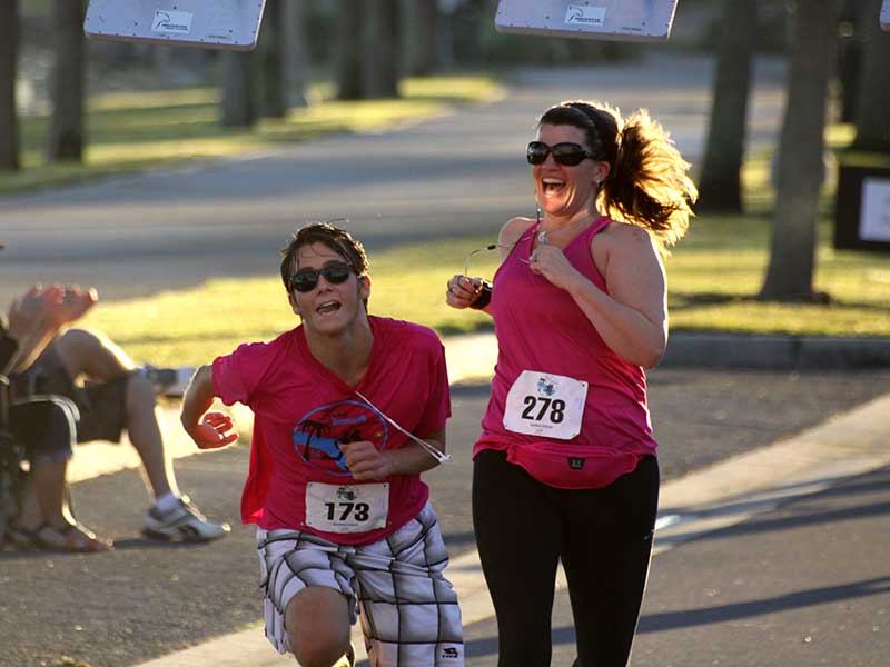 Runners crossing the finish line in the 2014 Sanford Riverwalk 5K
