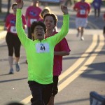 Runners crossing the finish line in the 2014 Sanford Riverwalk 5K